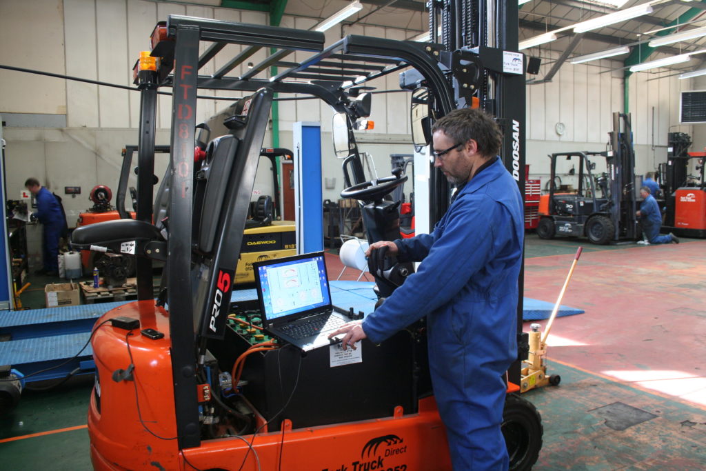 Picture of staff member working on a forktruck the company hires in Essex and Suffolk