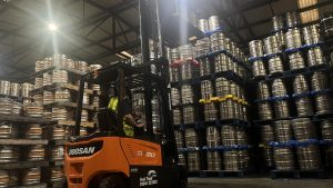 Doosan electric counterbalance forklift truck at Hills Prospect lifting beer kegs.