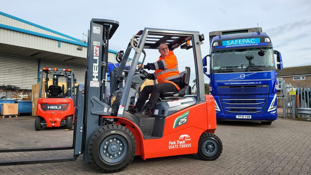 Mr Flynn of SafePac on his brand new Lithium HELI counterbalance forklift truck outside of SafePac